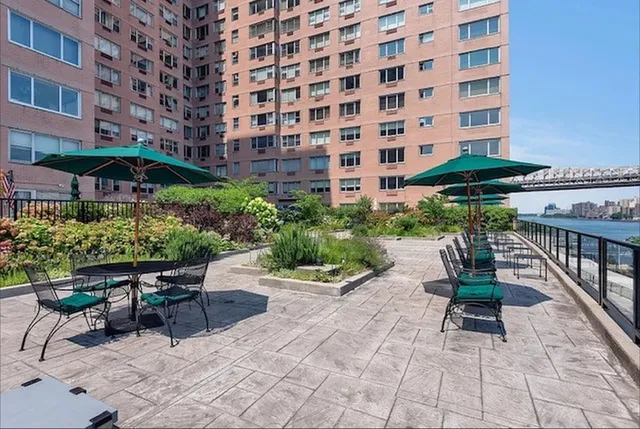 a view of a patio with a table and chairs