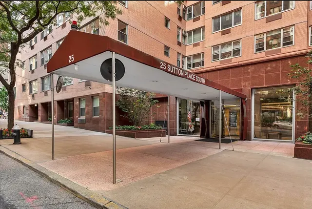 a view of a building with a tree in front of it