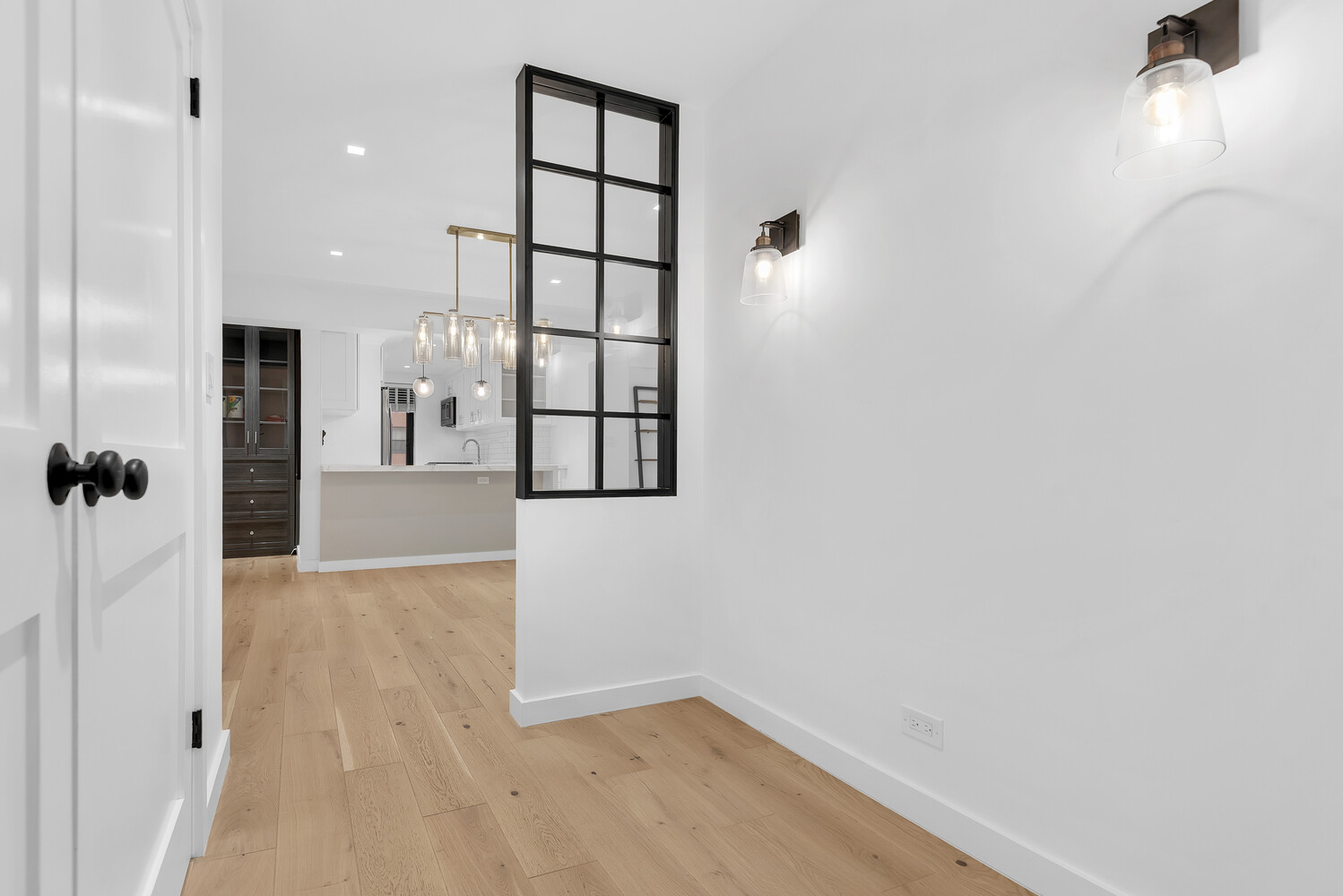 25 Sutton Place South, Unit 14A Manhattan, NY 10022 - Photo 6 of 17 a view of livingroom with hardwood floor and window