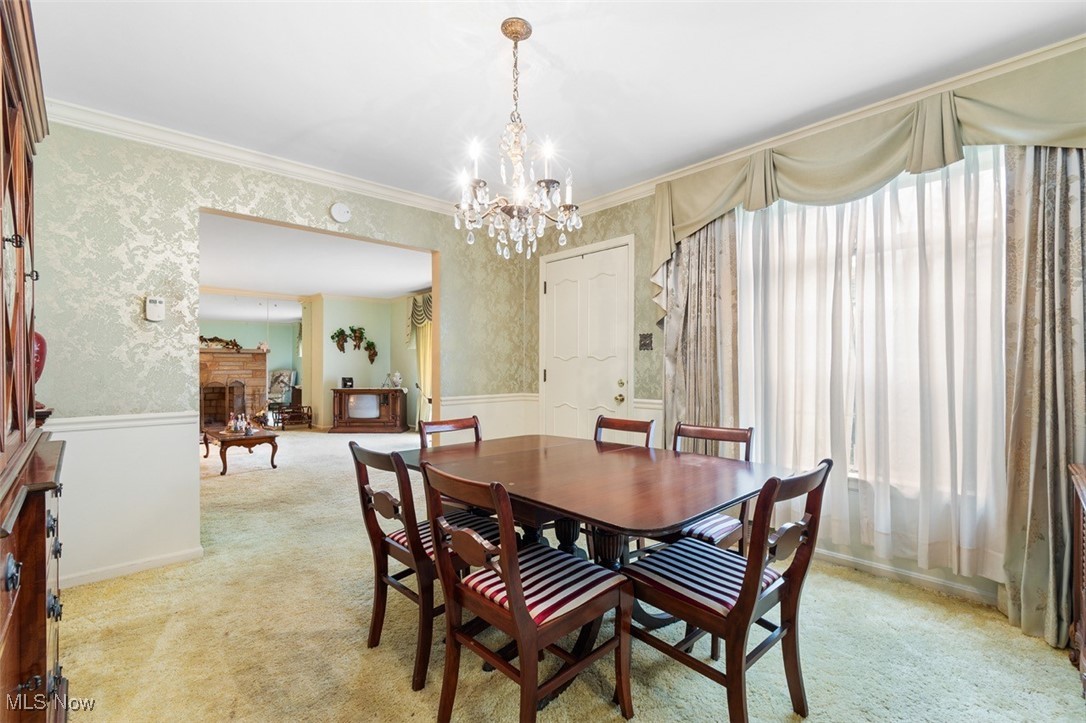 3265 Ridgewood Road Akron, OH 44333 - Photo 11 of 29 Dining room featuring a wealth of natural light, light colored carpet, and crown molding