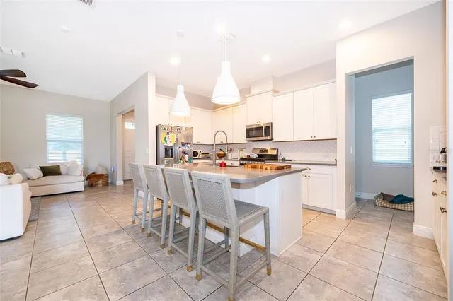 a kitchen with a table chairs and a refrigerator
