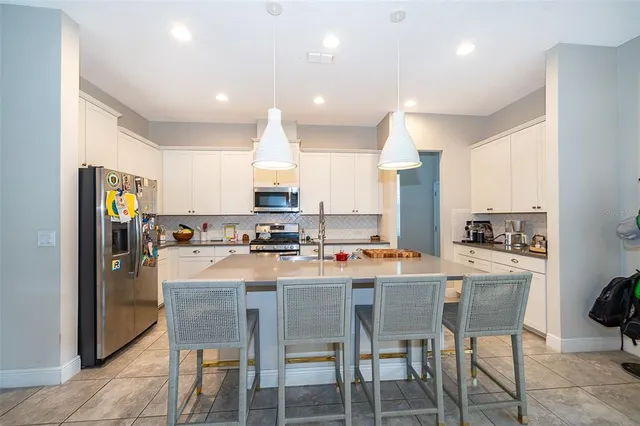 a kitchen with appliances a sink and cabinets