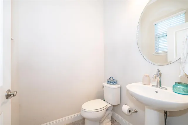 a bathroom with a sink a mirror and a toilet