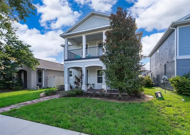 a front view of house with yard and green space