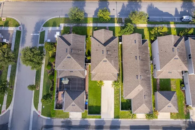 an aerial view of houses with a yard