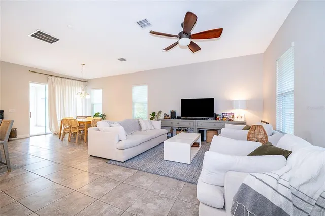 a living room with furniture a window and a flat screen tv