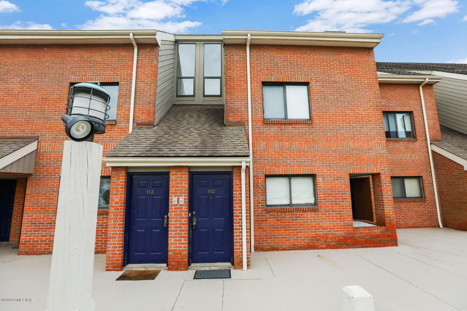 11 River Road, Unit 112 Cos Cob, CT 06807 - Photo 2 of 27 a front view of a house with garden