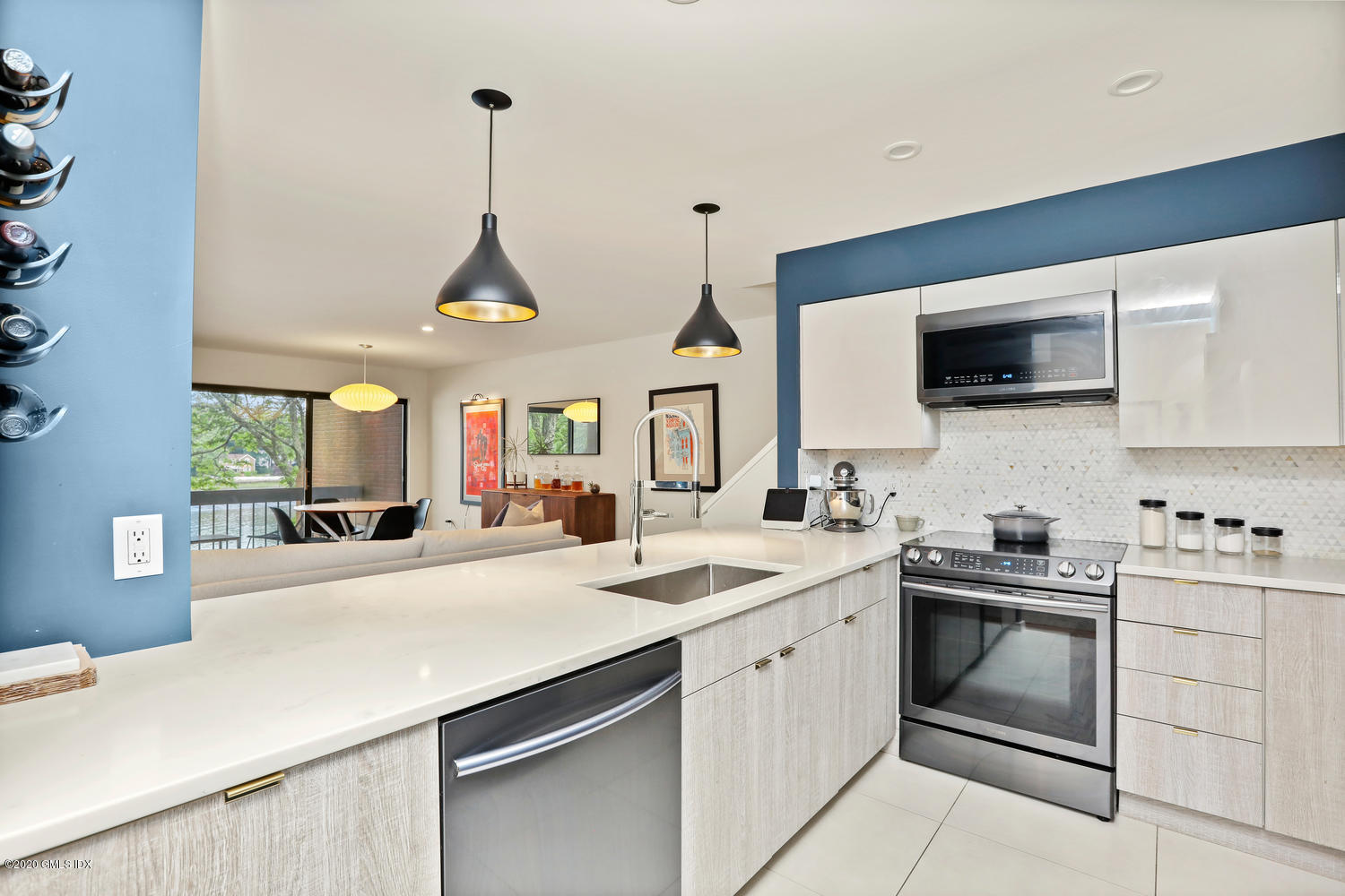 11 River Road, Unit 112 Cos Cob, CT 06807 - Photo 3 of 27 a kitchen with a sink a stove and microwave