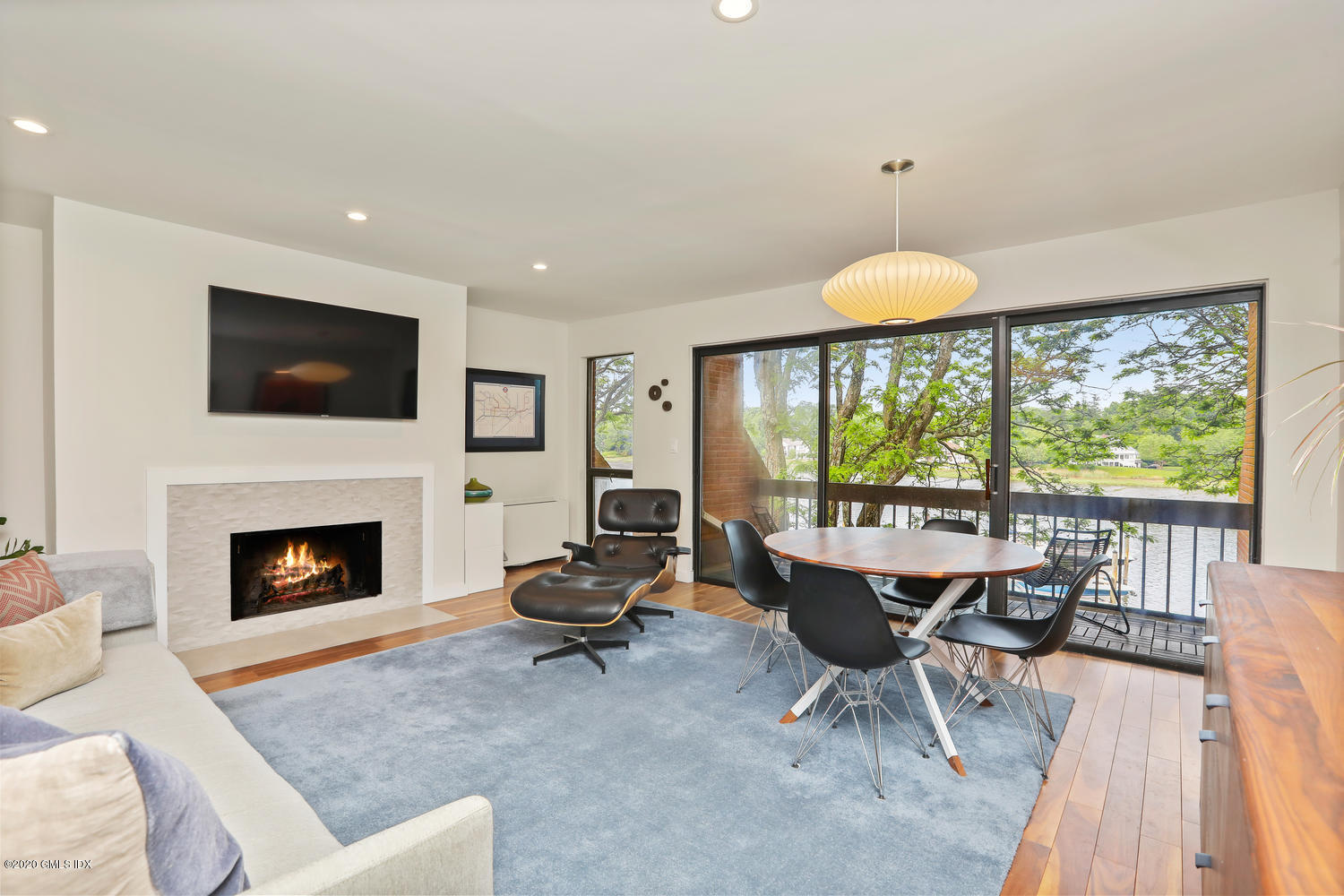 11 River Road, Unit 112 Cos Cob, CT 06807 - Photo 5 of 27 a living room with furniture a fireplace and a flat screen tv