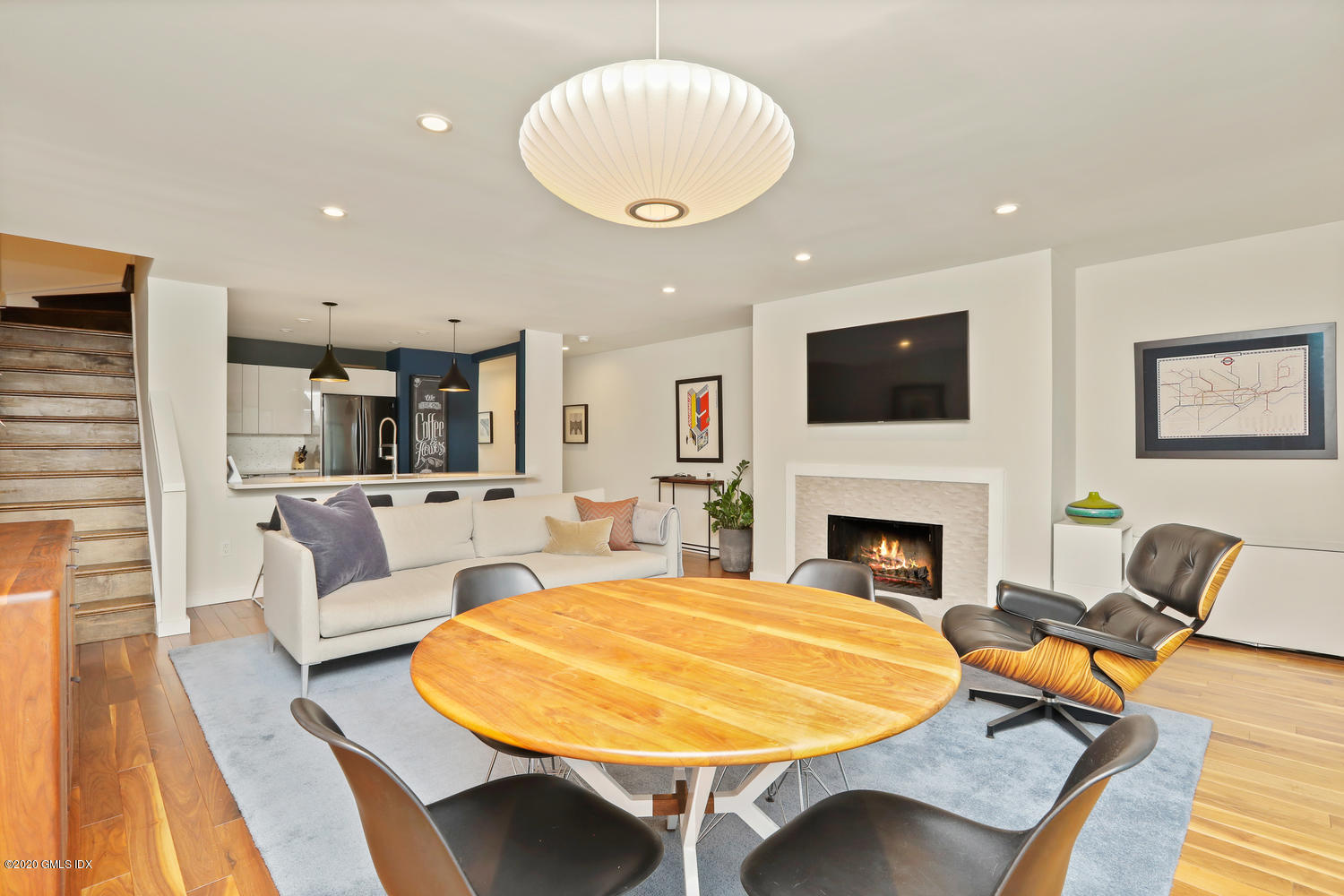 11 River Road, Unit 112 Cos Cob, CT 06807 - Photo 7 of 27 a living room with furniture a fireplace and a flat screen tv