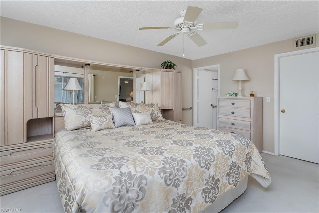 5515 Rattlesnake Hammock Road, Unit 205 Naples, FL 34113 - Photo 14 of 46 Carpeted living room featuring ceiling fan
