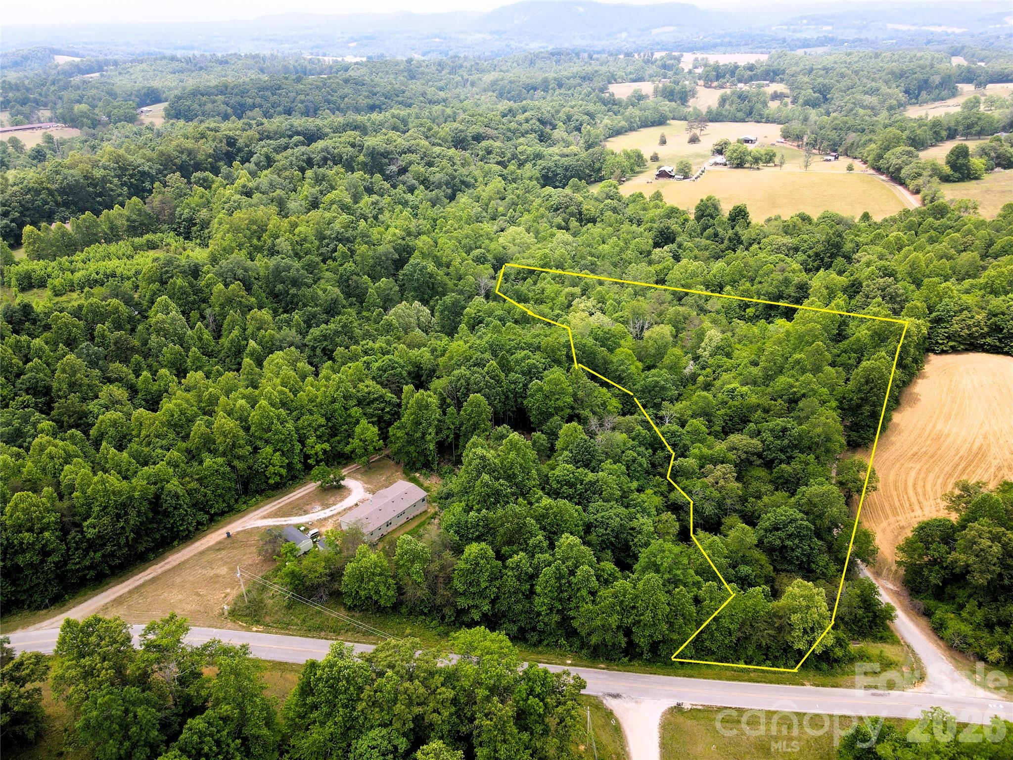 6 Hopewell Church Road, Unit 6 Hiddenite, NC 28636 - Photo 16 of 33 an aerial view of residential houses with outdoor space and trees