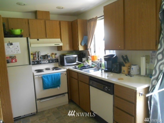 506 208th Street Southeast, Unit 1 & 2 Bothell, WA 98012 - Photo 4 of 10 a kitchen with a sink a stove and a refrigerator