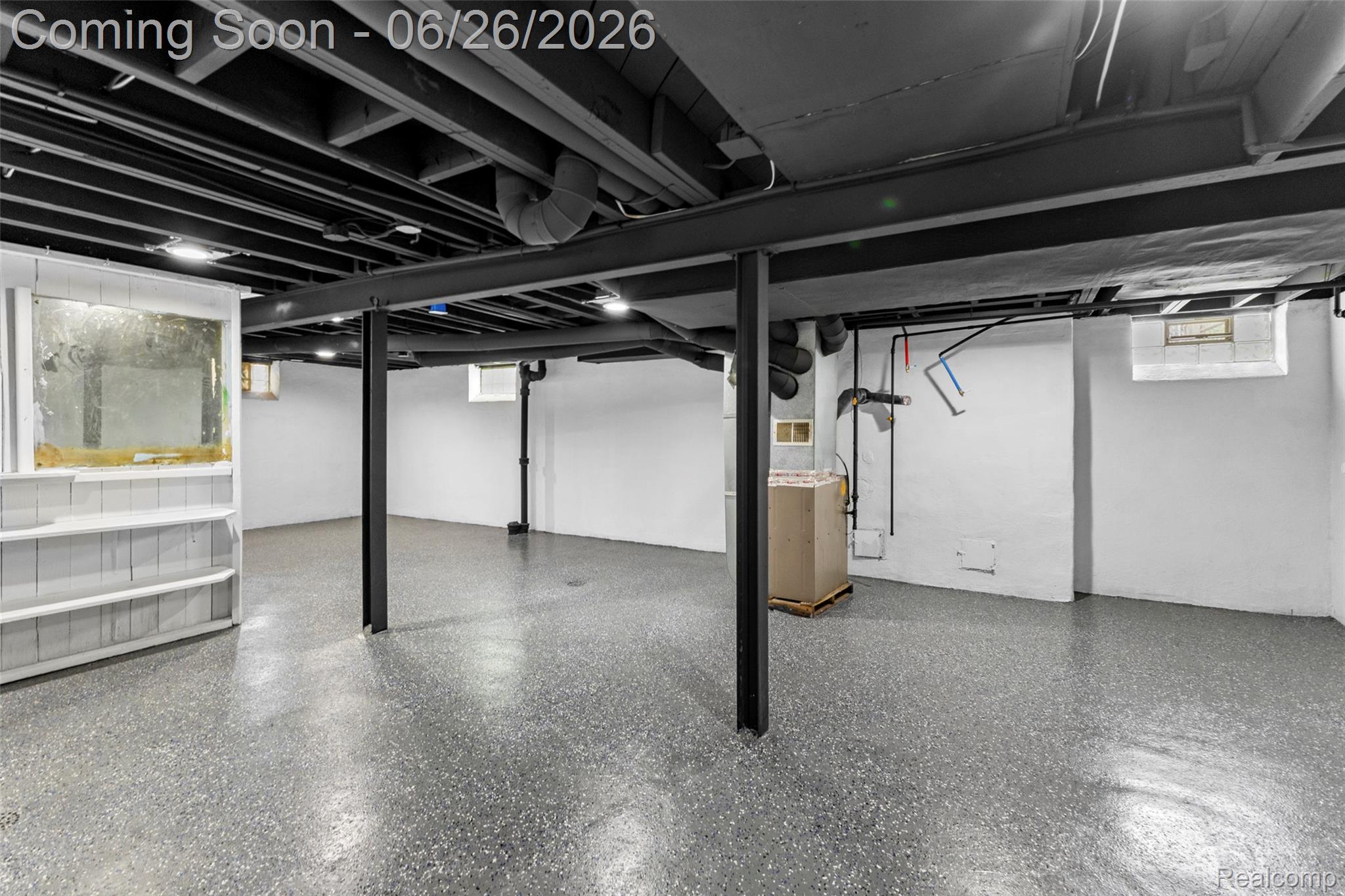 8310 Whitcomb Detroit, MI 48228 - Photo 26 of 26 Spacious lower level featuring exposed ceiling joists, support beams, recessed lighting, concrete flooring, and an integrated built-in shelving unit