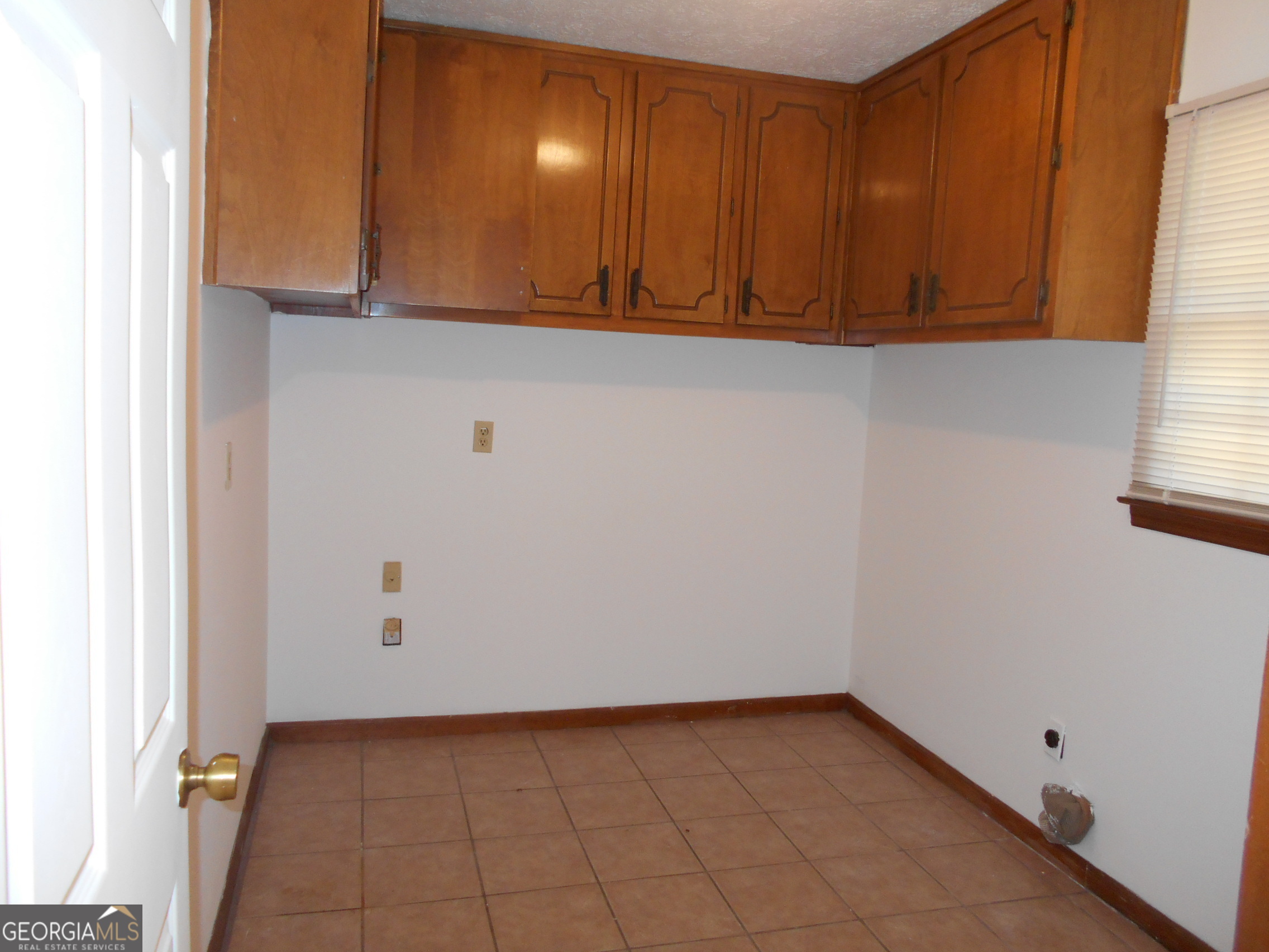 551 Racetrack Road McDonough, GA 30252 - Photo 5 of 11 a view of a utility room with wooden cabinet