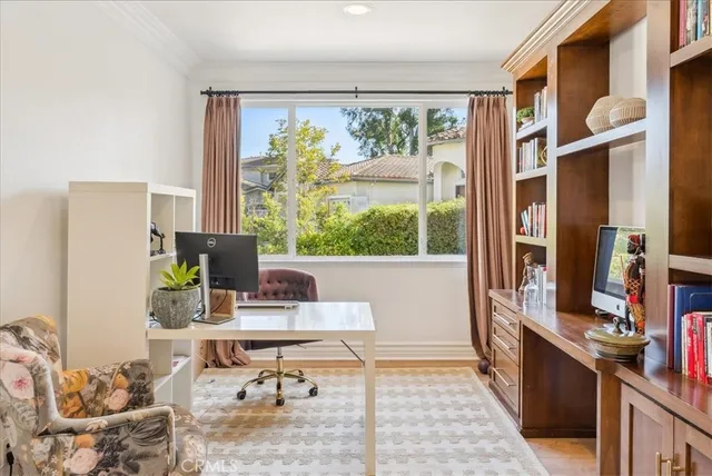 a work room with furniture a rug and a window