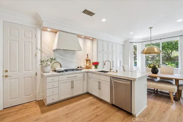 a kitchen with sink stove and cabinets