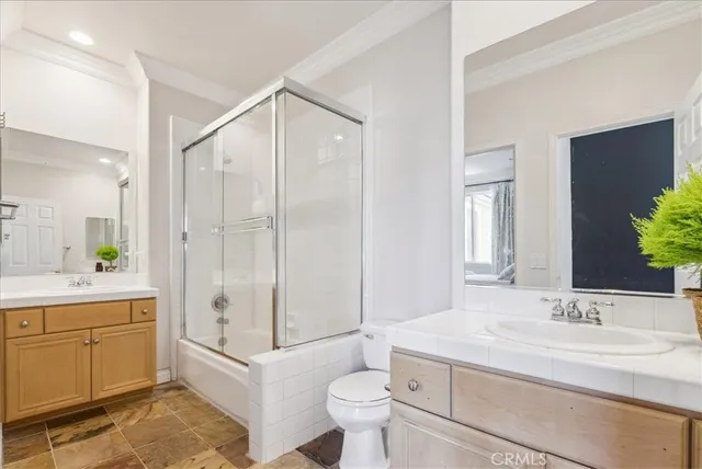 a bedroom with a bed and a potted plant