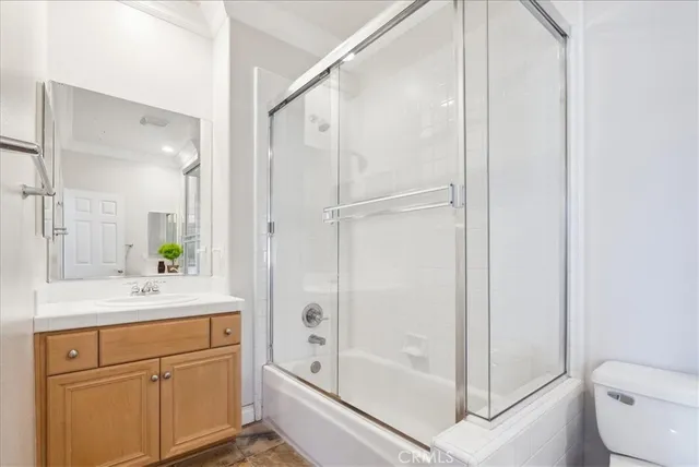 a bed sitting in a spacious bedroom next to a window