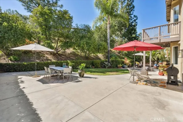 a view of a patio with couches table and chairs and potted plants