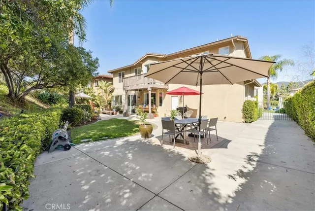 a view of a house with backyard porch and sitting area