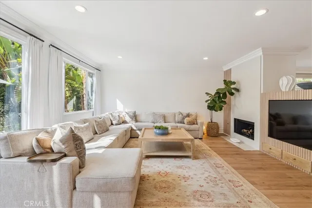 a living room with furniture fireplace and flat screen tv