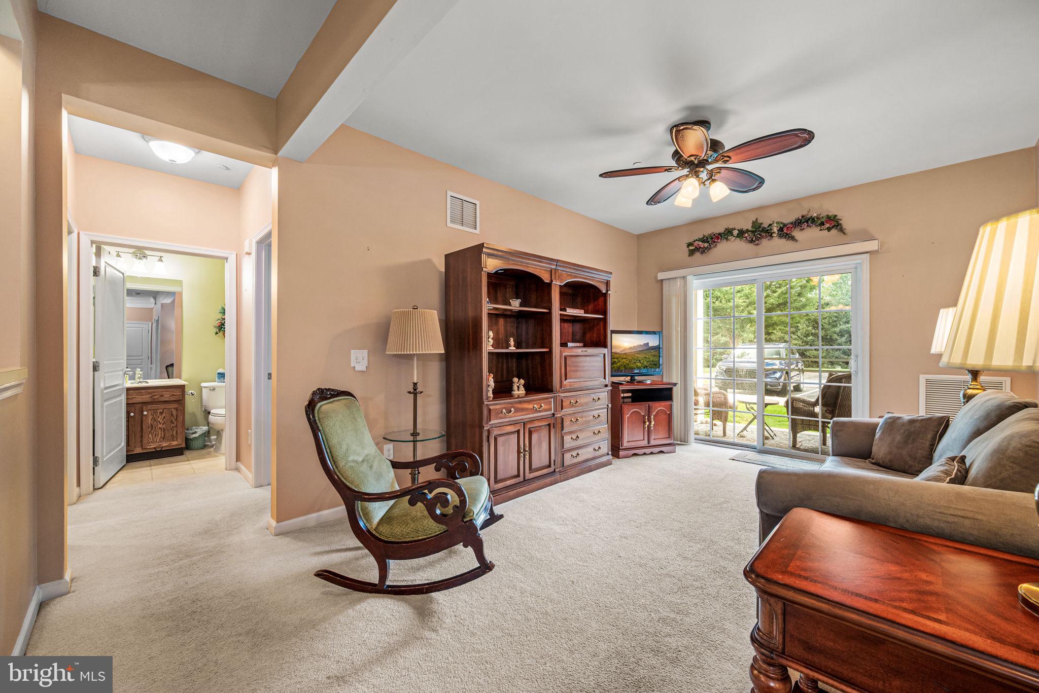 113 Creekside Drive, Unit 3 Brookhaven, PA 19015 - Photo 13 of 26 a living room with furniture a window and a flat screen tv