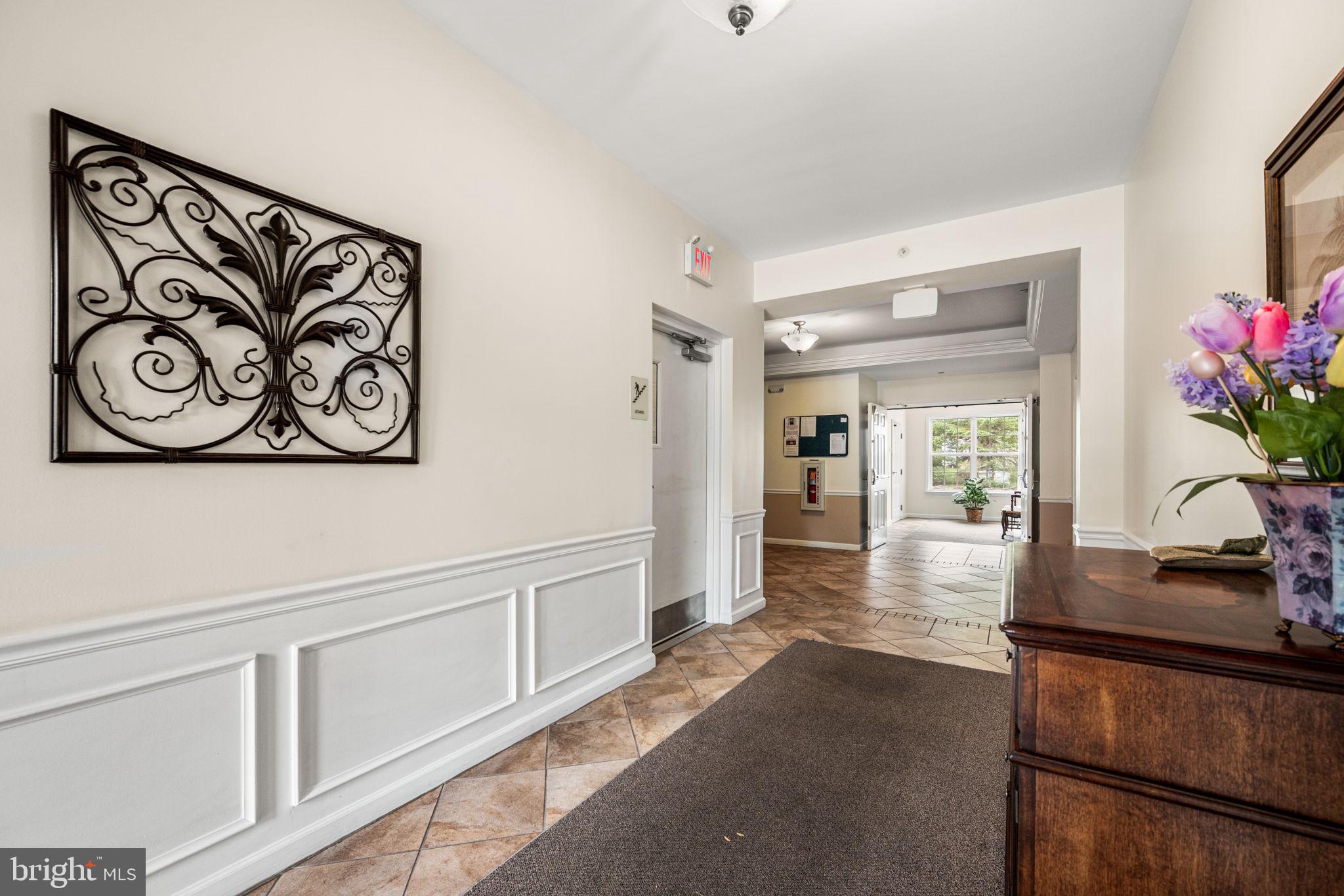 113 Creekside Drive, Unit 3 Brookhaven, PA 19015 - Photo 4 of 26 a view of a hallway to a livingroom with furniture