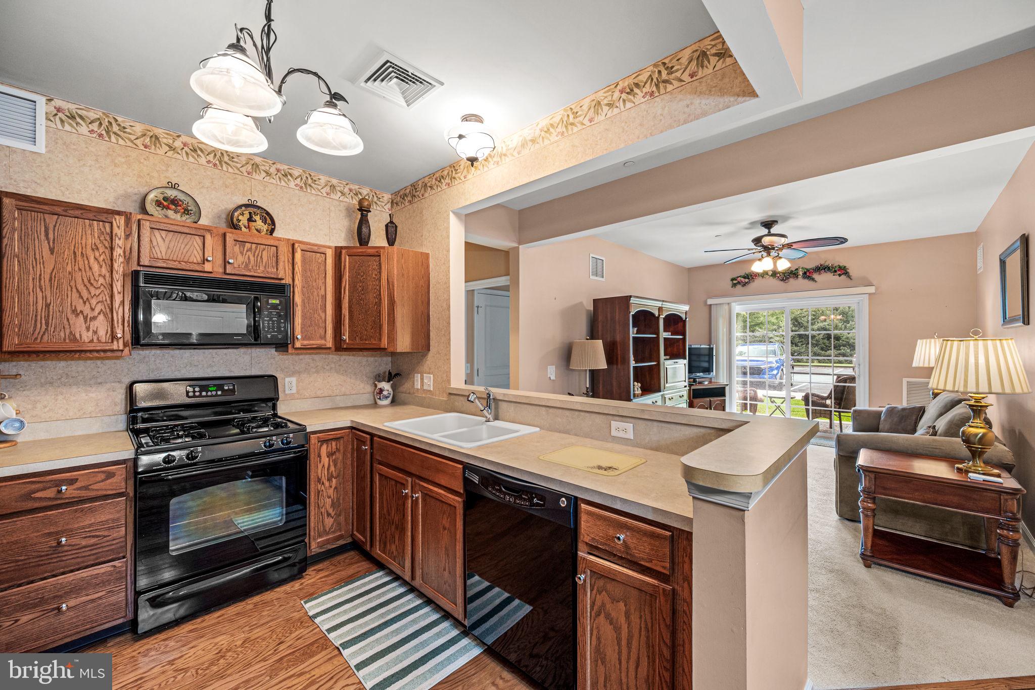 113 Creekside Drive, Unit 3 Brookhaven, PA 19015 - Photo 8 of 26 a kitchen with stove a sink and cabinets