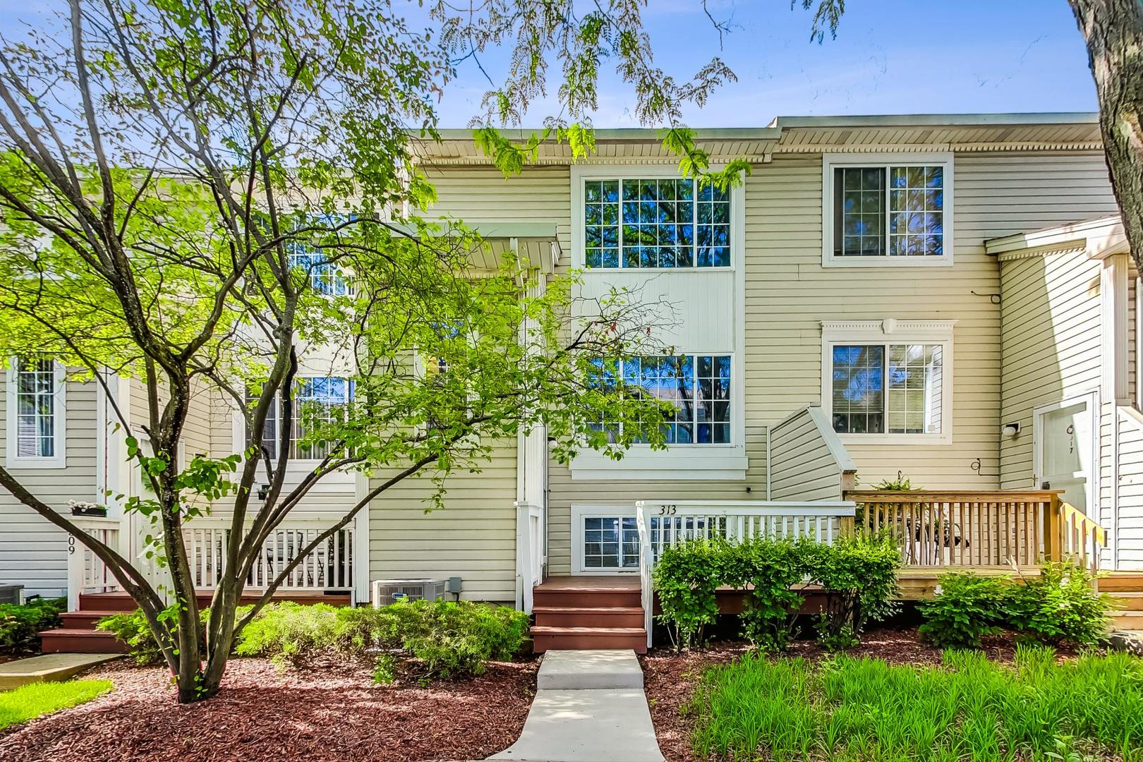313 Rosebud Court, Unit 313 Bolingbrook, IL 60440 - Photo 1 of 31 a front view of a house with garden