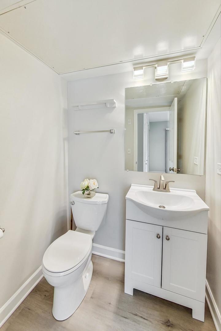 313 Rosebud Court, Unit 313 Bolingbrook, IL 60440 - Photo 13 of 31 a bathroom with a toilet sink and mirror