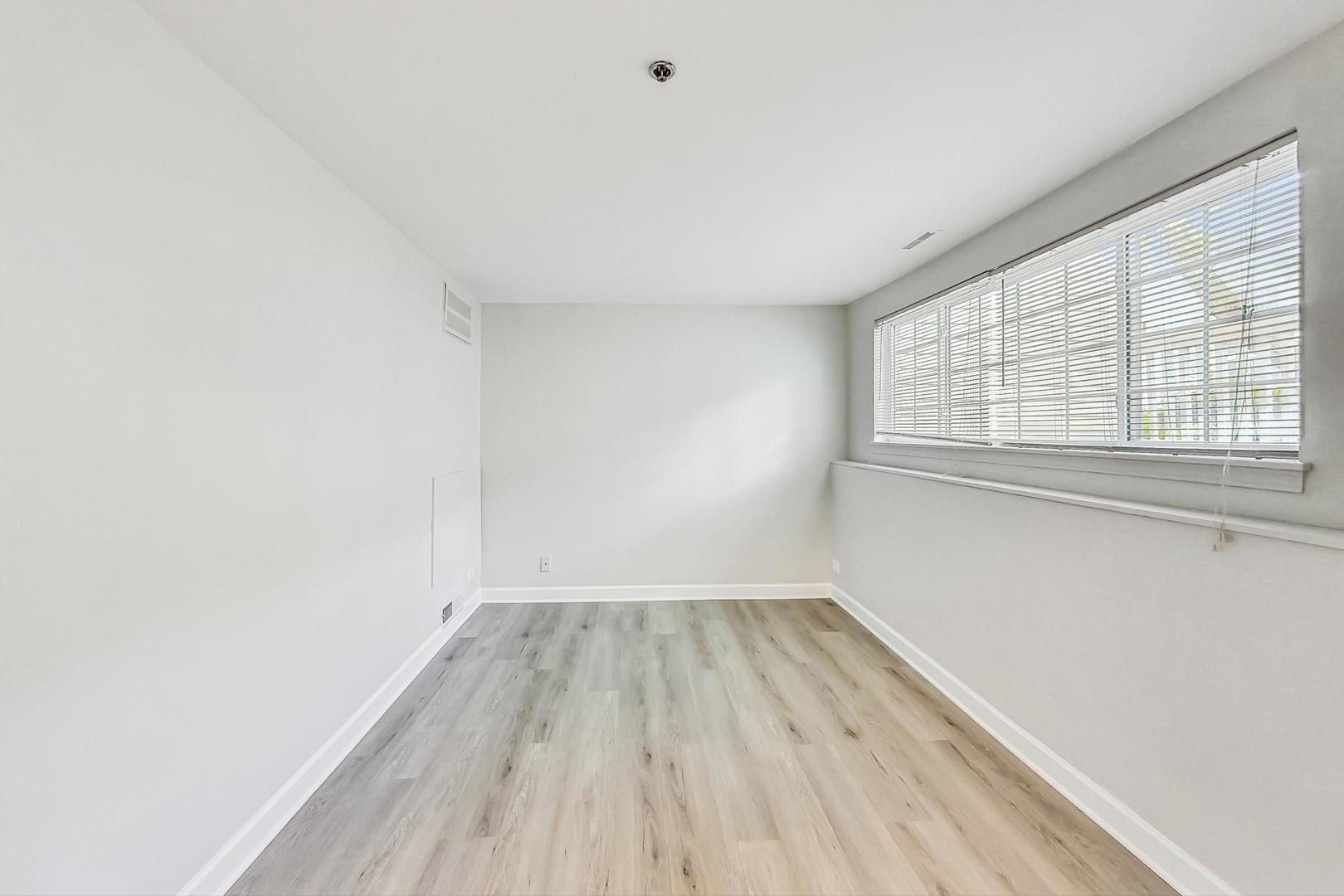 313 Rosebud Court, Unit 313 Bolingbrook, IL 60440 - Photo 15 of 31 an empty room with wooden floor and windows