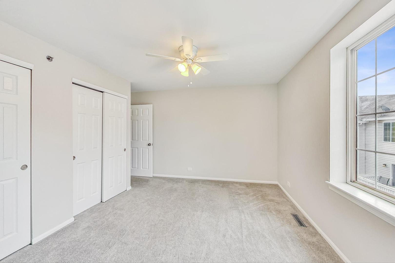 313 Rosebud Court, Unit 313 Bolingbrook, IL 60440 - Photo 16 of 31 an empty room with windows and fan