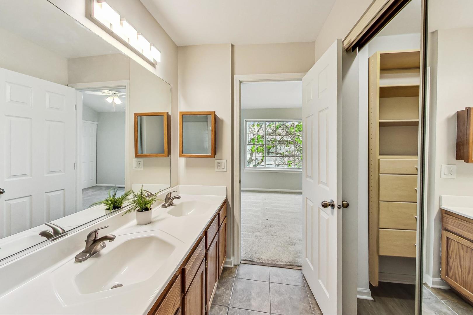 313 Rosebud Court, Unit 313 Bolingbrook, IL 60440 - Photo 18 of 31 a bathroom with a sink and a mirror
