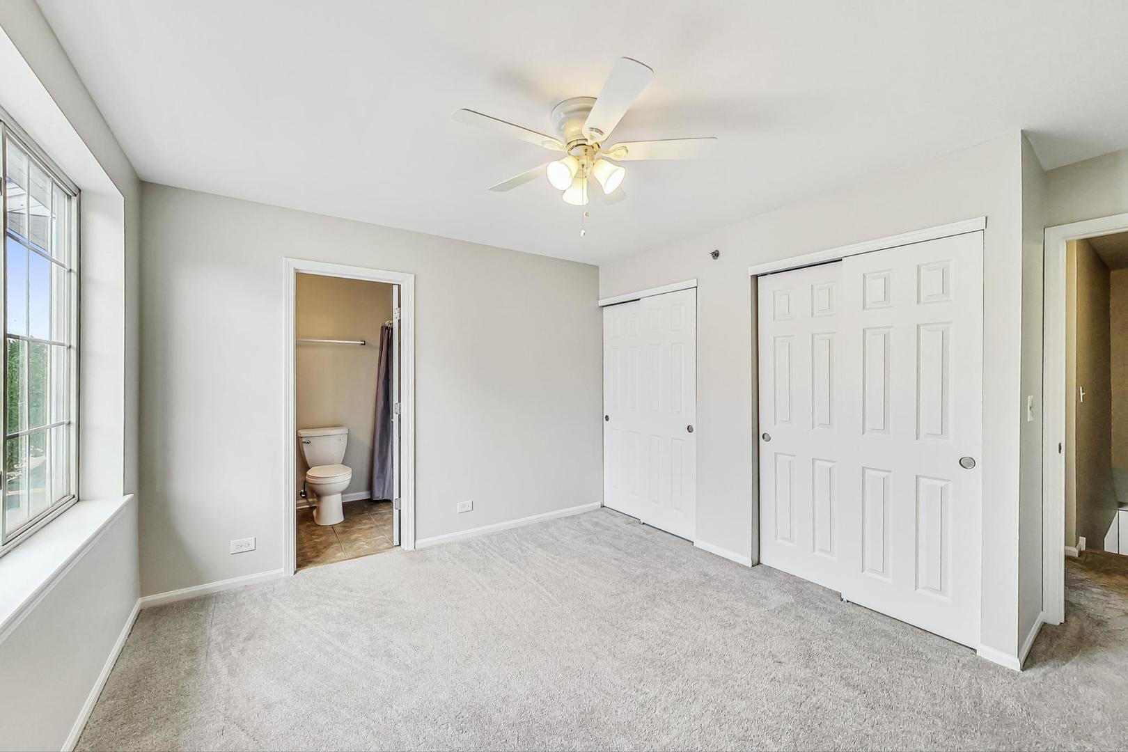 313 Rosebud Court, Unit 313 Bolingbrook, IL 60440 - Photo 19 of 31 a view of a livingroom with a ceiling fan and window