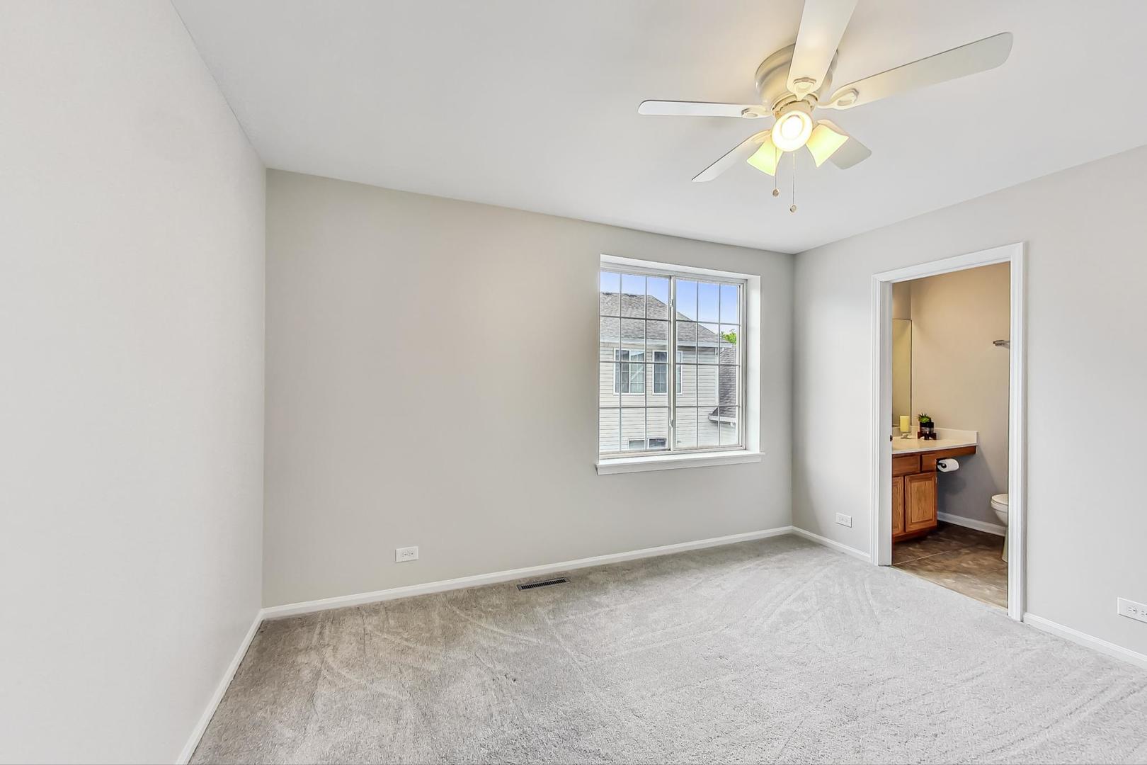 313 Rosebud Court, Unit 313 Bolingbrook, IL 60440 - Photo 20 of 31 an empty room with windows and ceiling fan