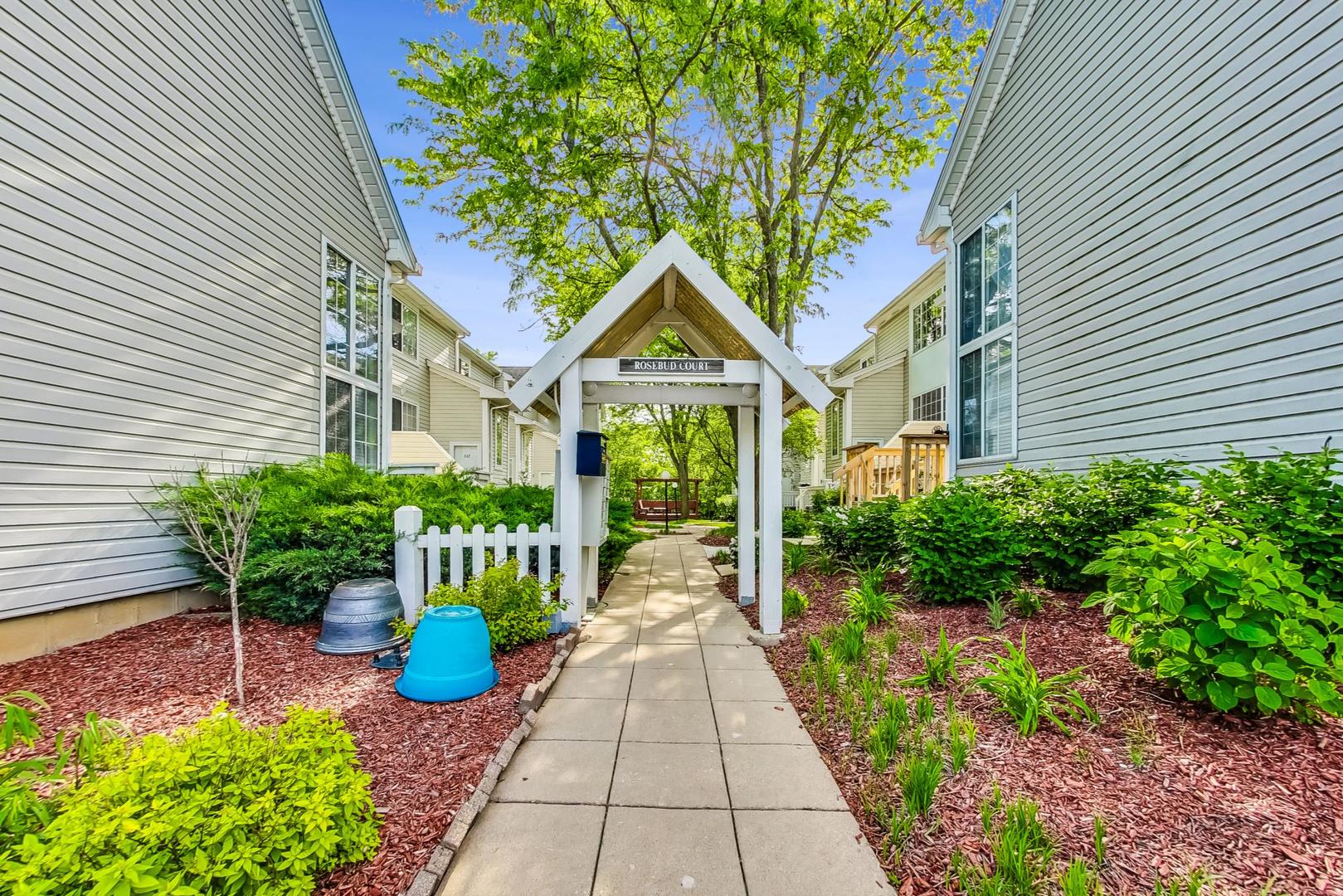 313 Rosebud Court, Unit 313 Bolingbrook, IL 60440 - Photo 2 of 31 a front view of a house with a porch