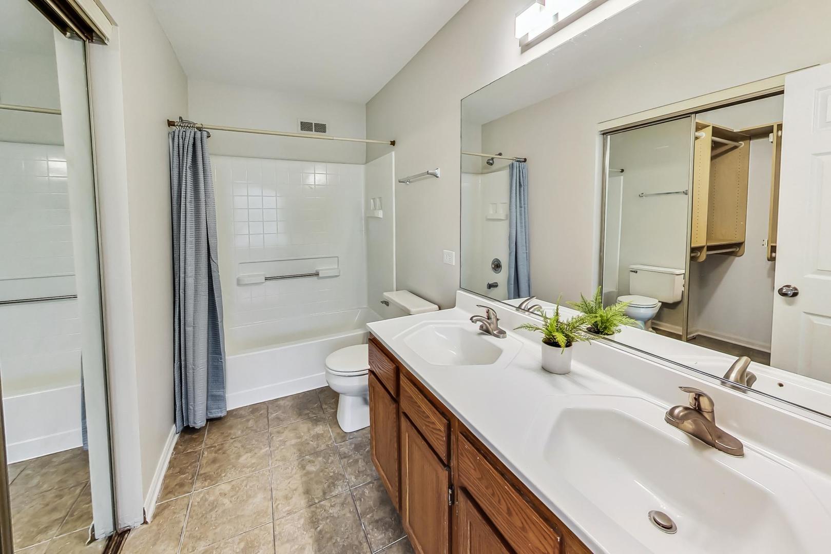 313 Rosebud Court, Unit 313 Bolingbrook, IL 60440 - Photo 21 of 31 a bathroom with a sink double vanity and a mirror