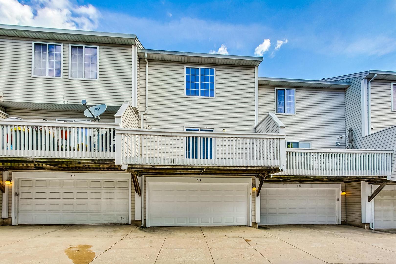 313 Rosebud Court, Unit 313 Bolingbrook, IL 60440 - Photo 30 of 31 a view of a patio with table and chairs