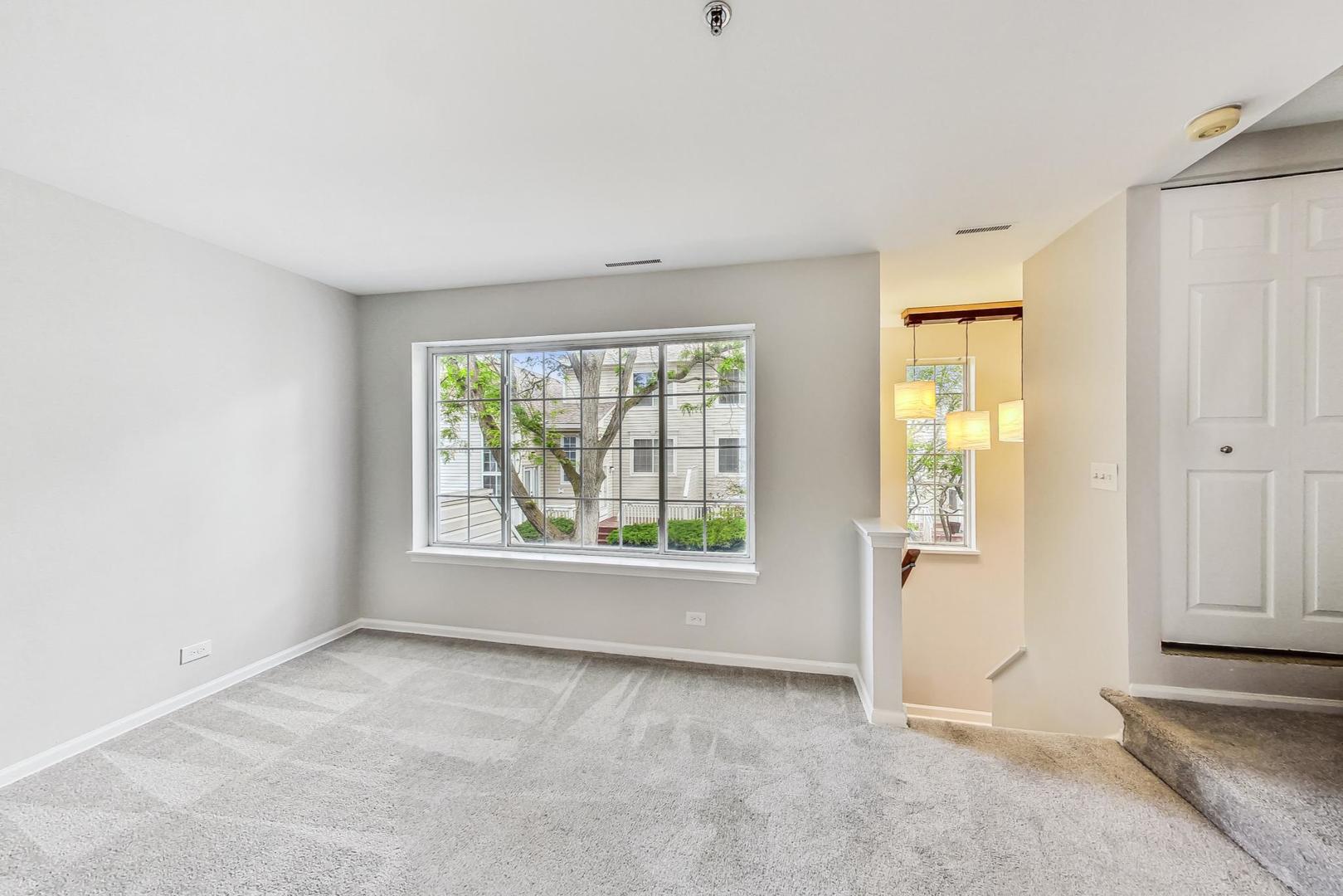 313 Rosebud Court, Unit 313 Bolingbrook, IL 60440 - Photo 5 of 31 an empty room with windows