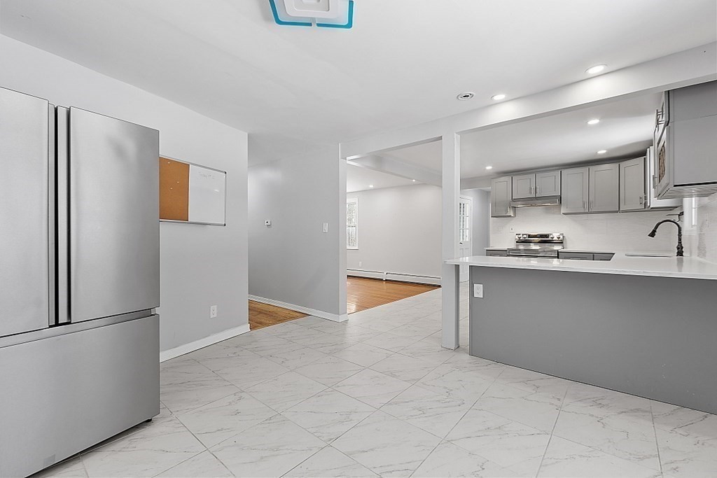 11 Boucher Road Lunenburg, MA 01462 - Photo 13 of 34 a kitchen with stainless steel appliances granite countertop a refrigerator and a sink