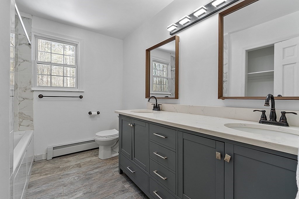 11 Boucher Road Lunenburg, MA 01462 - Photo 25 of 34 a bathroom with a double vanity sink a toilet and a mirror