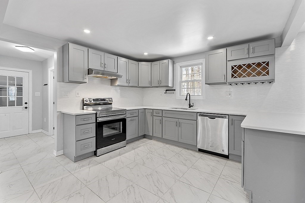 11 Boucher Road Lunenburg, MA 01462 - Photo 8 of 34 a kitchen with stainless steel appliances a stove sink and cabinets