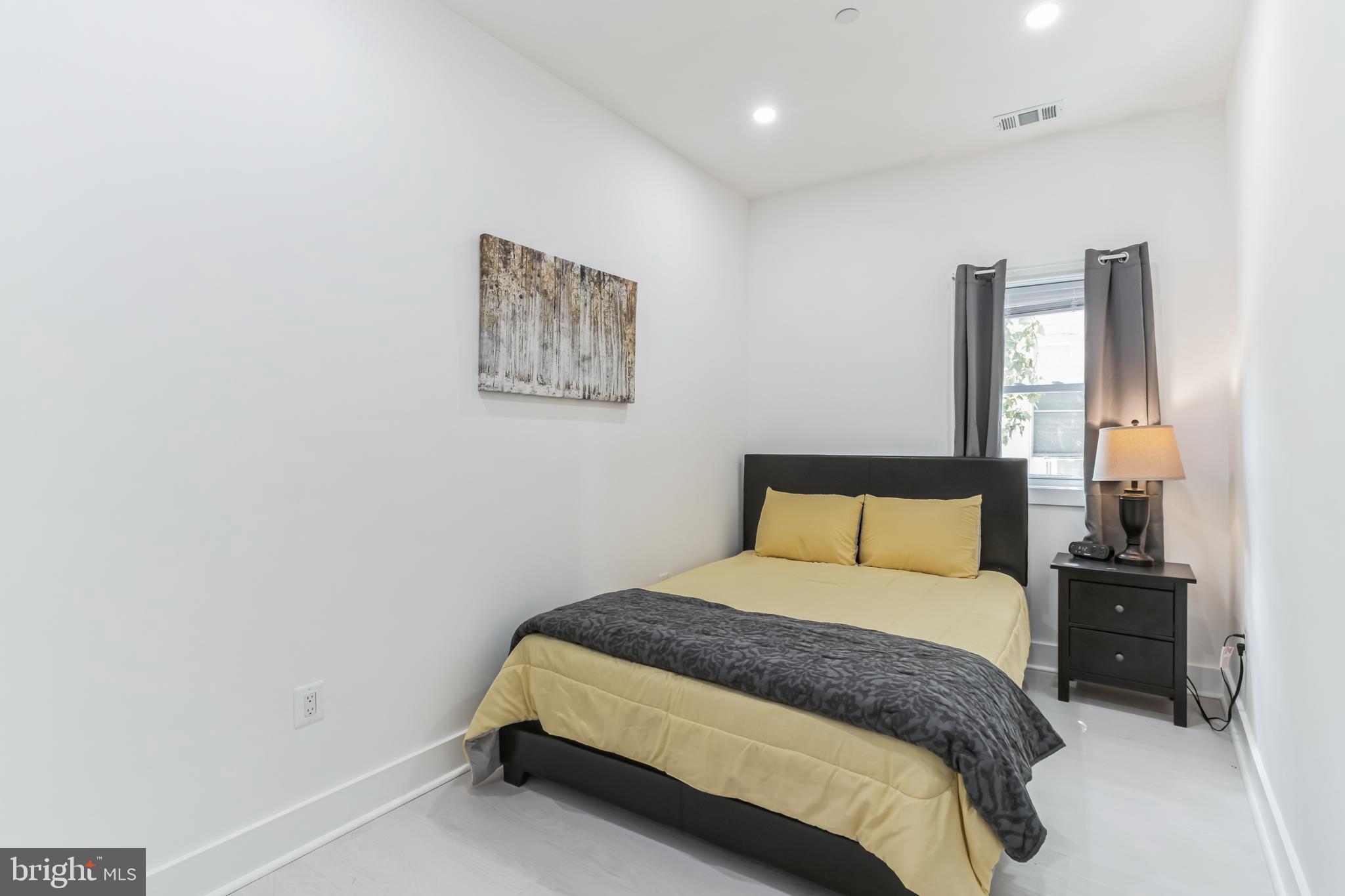 33 Florida Avenue Northeast, Unit 3 Washington, DC 20002 - Photo 11 of 15 a bedroom with a bed and wooden floor