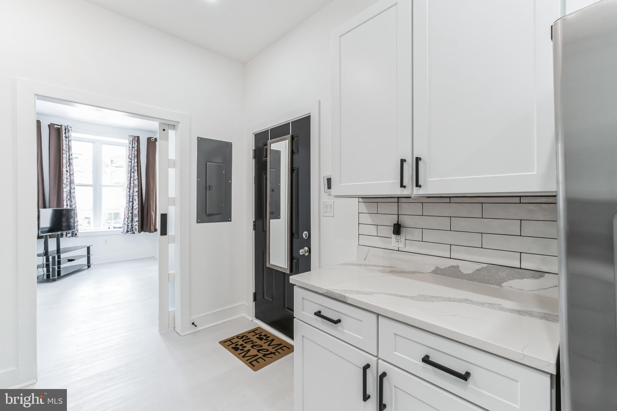 33 Florida Avenue Northeast, Unit 3 Washington, DC 20002 - Photo 3 of 15 a kitchen with a refrigerator and white cabinets