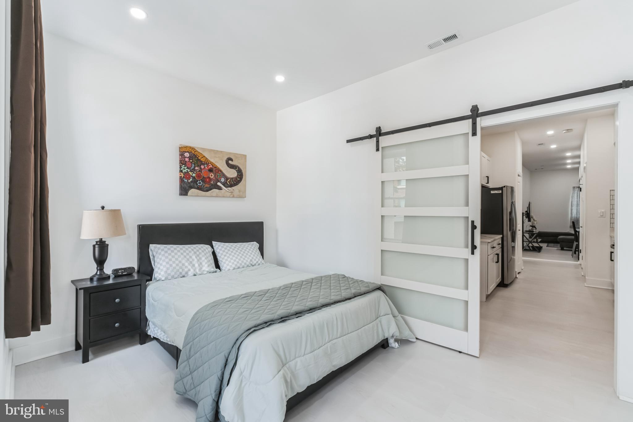 33 Florida Avenue Northeast, Unit 3 Washington, DC 20002 - Photo 5 of 15 a bedroom with a bed and a walk in closet