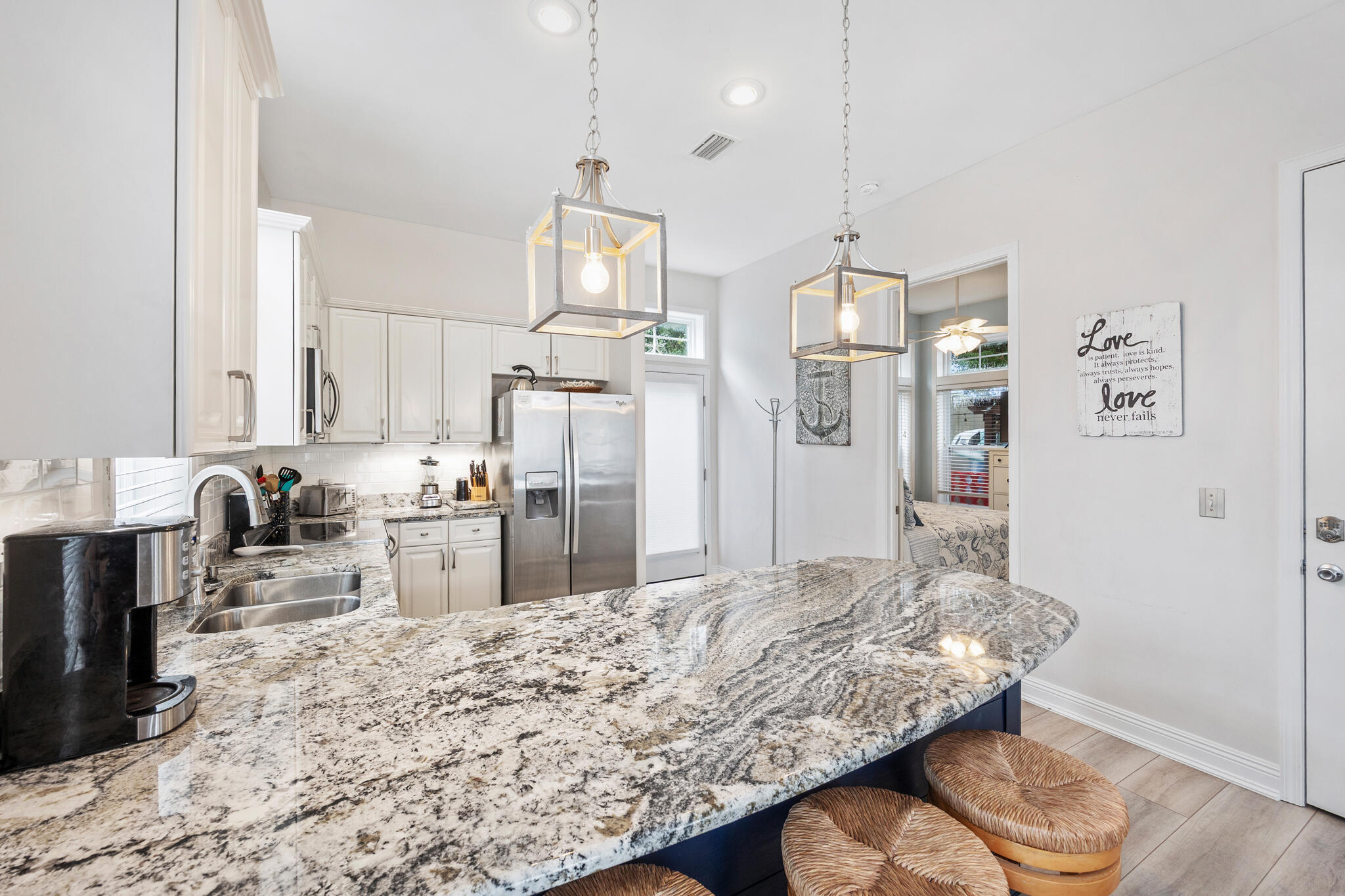 233 Redfish Circle Santa Rosa Beach, FL 32459 - Photo 12 of 73 a kitchen with stainless steel appliances kitchen island granite countertop a sink refrigerator and cabinets
