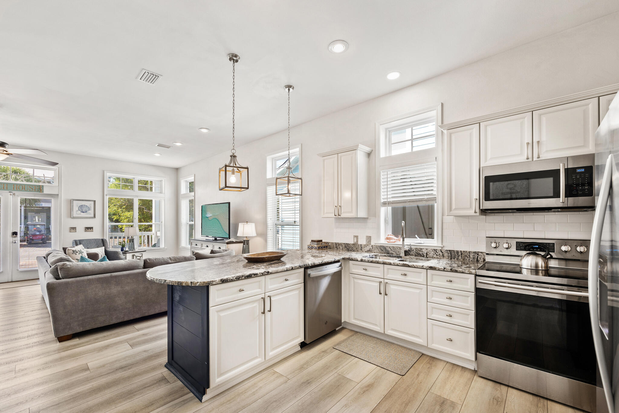 233 Redfish Circle Santa Rosa Beach, FL 32459 - Photo 13 of 73 a kitchen with stainless steel appliances kitchen island granite countertop a sink a stove top oven a counter space and cabinets