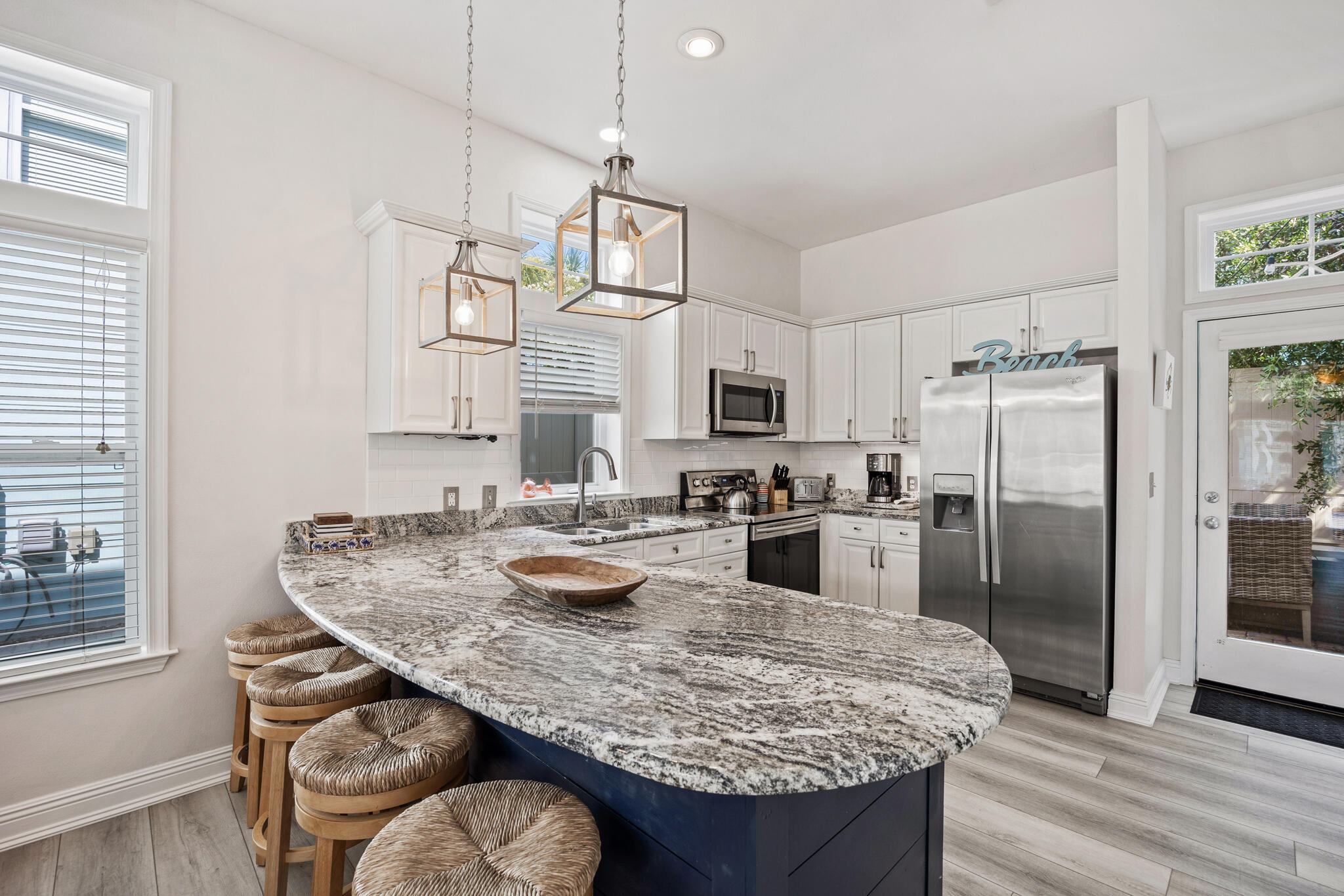 233 Redfish Circle Santa Rosa Beach, FL 32459 - Photo 16 of 73 a kitchen with white cabinets and stainless steel appliances