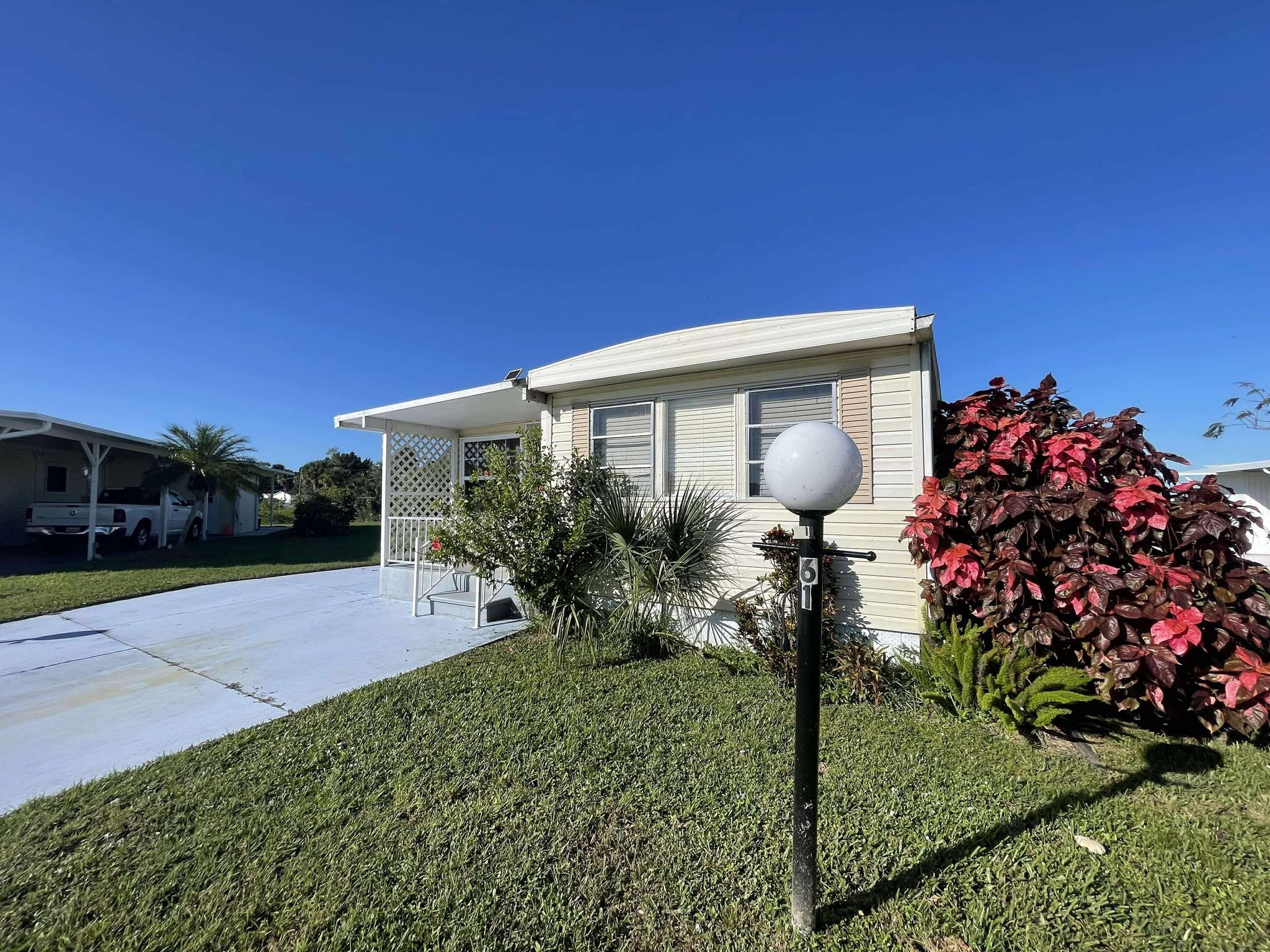 1601 Highway 441, Unit 61 Okeechobee, FL 34974 - Photo 1 of 35 a front view of a house with garden